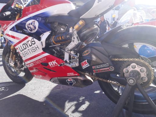 Close-up of a racing motorcycle showcasing its engine and chain details.