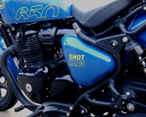 Close-up of a blue motorcycle with "SHOT 2020" and a sporty design.