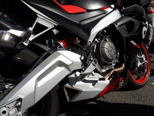 Black and silver sports motorcycle with red accents and detailed design elements.