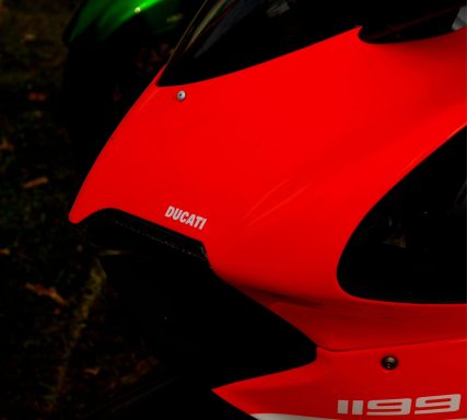 Close-up of a red Ducati motorcycle with sleek design elements.